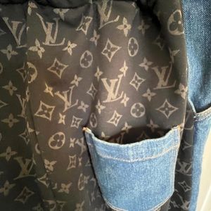 Monogramed distressed denim jeans.